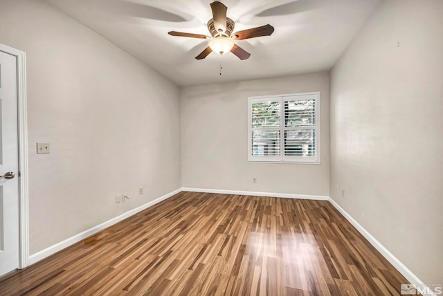 spare room with ceiling fan, baseboards, and wood finished floors