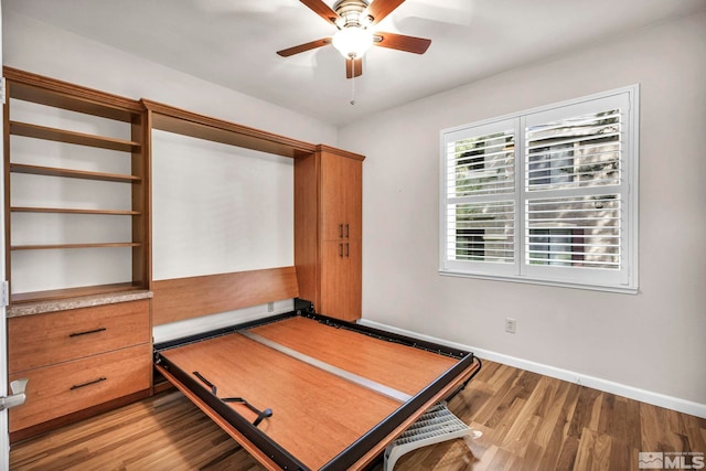 unfurnished bedroom featuring light wood-type flooring, ceiling fan, and baseboards