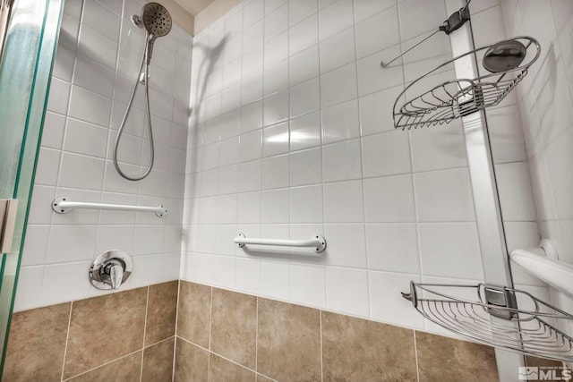 bathroom with a tile shower