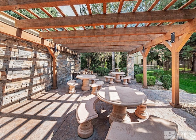 view of patio featuring fence and a pergola