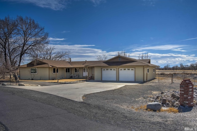 single story home featuring a garage, fence, and concrete driveway