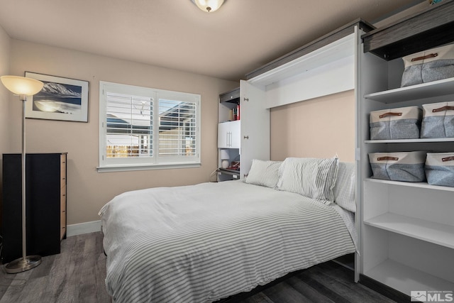 bedroom featuring baseboards and wood finished floors