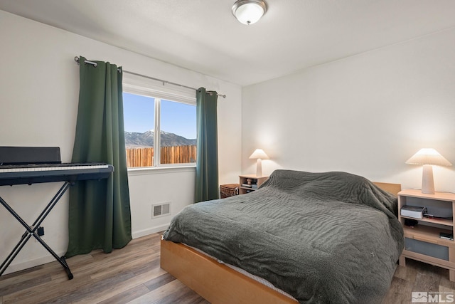 bedroom with wood finished floors and visible vents