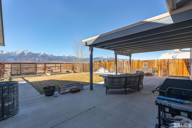 view of patio with an outdoor hangout area, central AC, a fenced backyard, and a mountain view