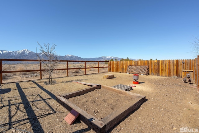 view of yard featuring a fenced backyard and a mountain view