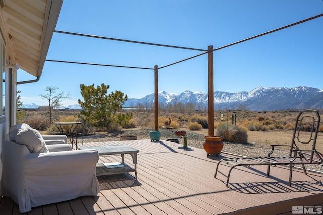 wooden terrace with a mountain view and outdoor lounge area