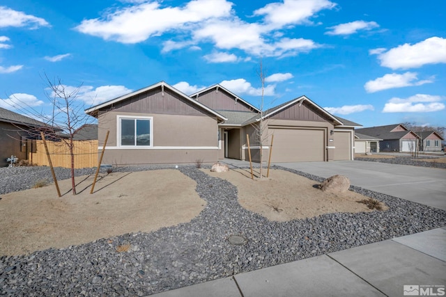 ranch-style home with a garage, concrete driveway, and fence