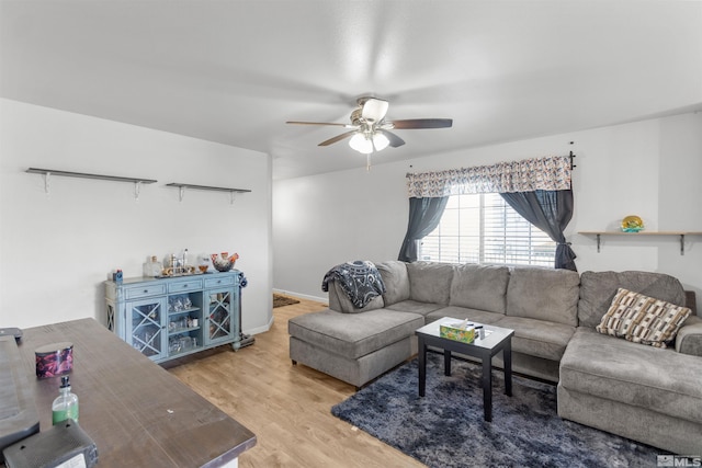 living area featuring ceiling fan and light wood-style flooring