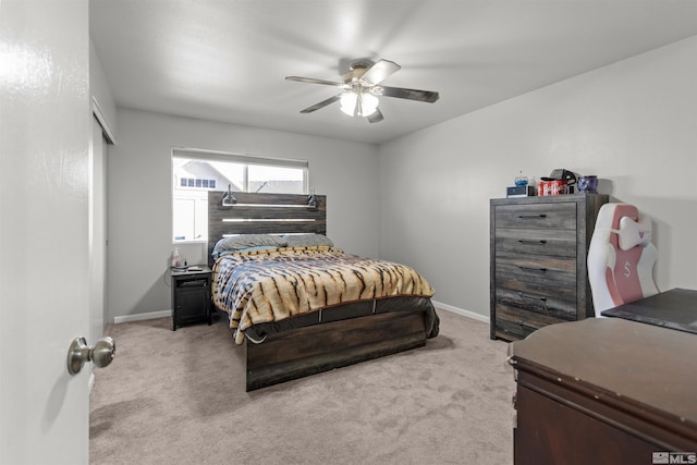 carpeted bedroom featuring ceiling fan and baseboards