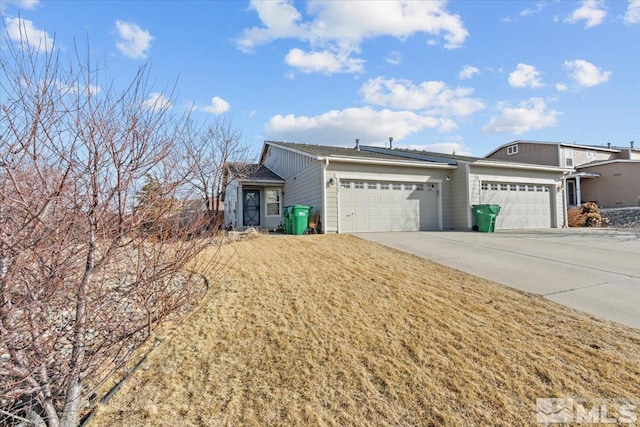 view of front of home featuring concrete driveway and an attached garage