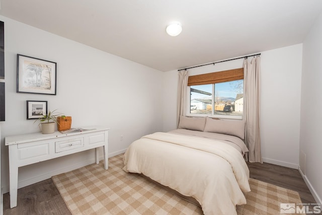 bedroom with light wood-style flooring and baseboards