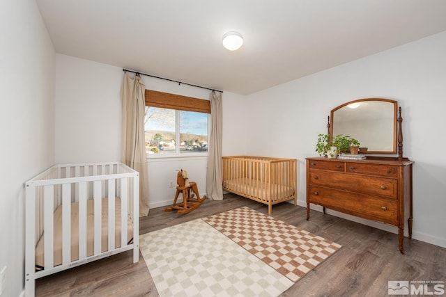 bedroom with baseboards and wood finished floors