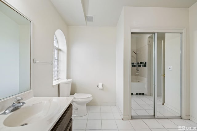 bathroom with visible vents, toilet, vanity,  shower combination, and tile patterned flooring