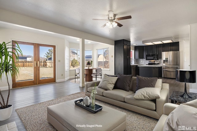 living area featuring light wood-style floors, french doors, and baseboards