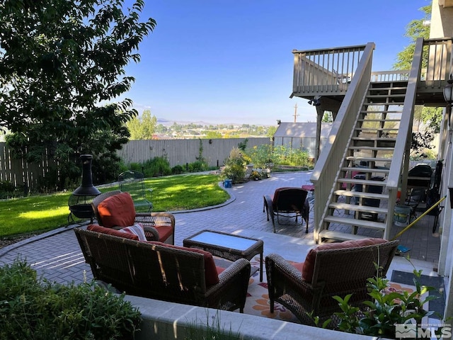 view of patio with stairs, outdoor lounge area, and a fenced backyard