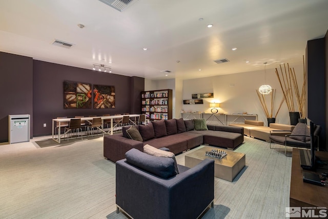 living room with carpet flooring, visible vents, and recessed lighting
