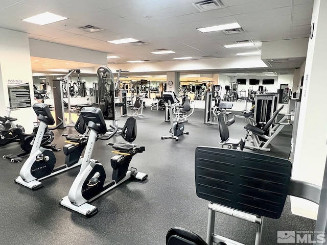 exercise room featuring a paneled ceiling and visible vents