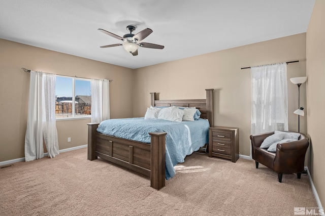 bedroom with light carpet, ceiling fan, and baseboards