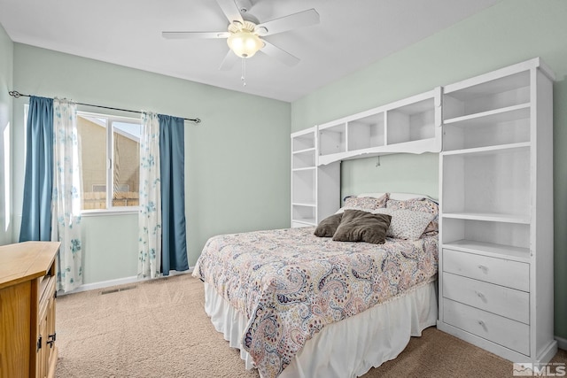 bedroom with visible vents, a ceiling fan, and carpet flooring