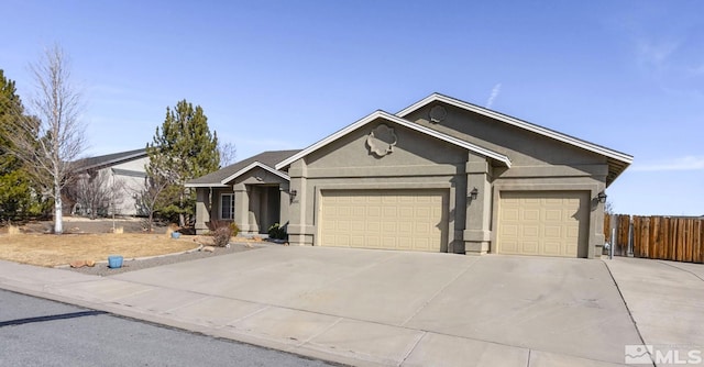 single story home with an attached garage, fence, concrete driveway, and stucco siding