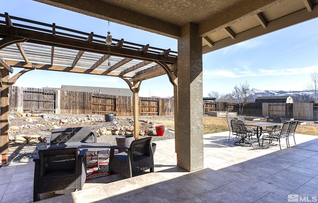 view of patio with outdoor dining space, a fenced backyard, and a pergola