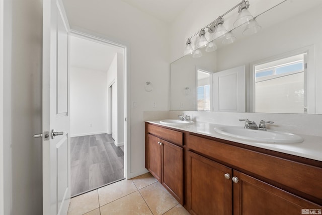 bathroom featuring double vanity, tile patterned flooring, and a sink