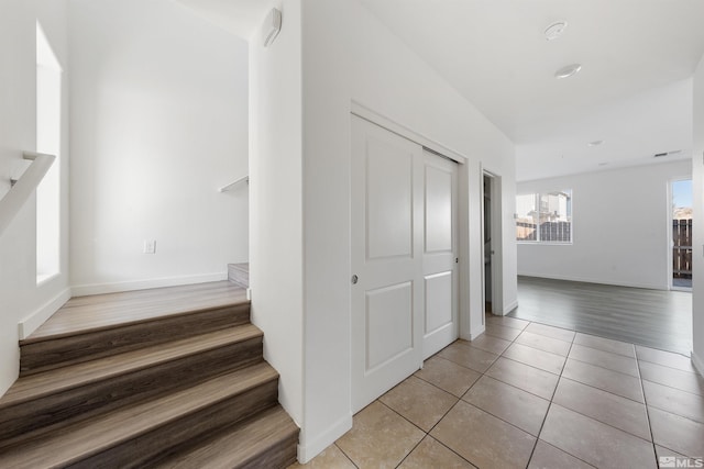 stairway featuring tile patterned flooring and baseboards