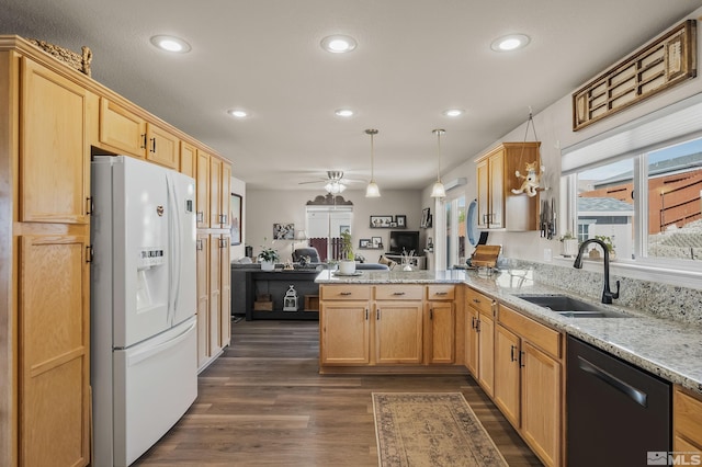 kitchen with dishwasher, open floor plan, a peninsula, white fridge with ice dispenser, and a sink