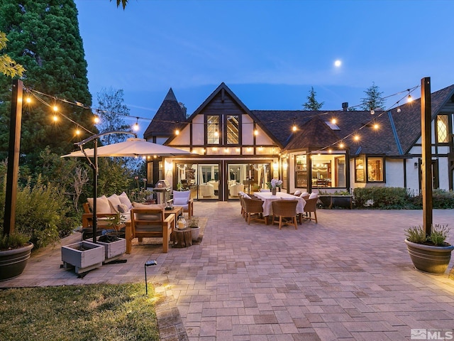 rear view of property with a patio area, an outdoor living space, and outdoor dining space