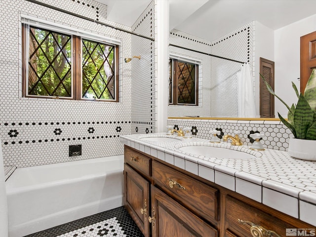 bathroom with a tub to relax in, curtained shower, a sink, and double vanity