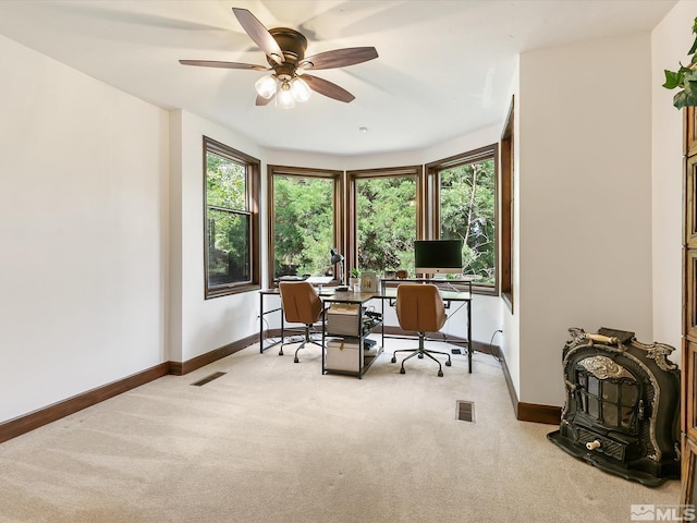 carpeted home office featuring ceiling fan, visible vents, and baseboards