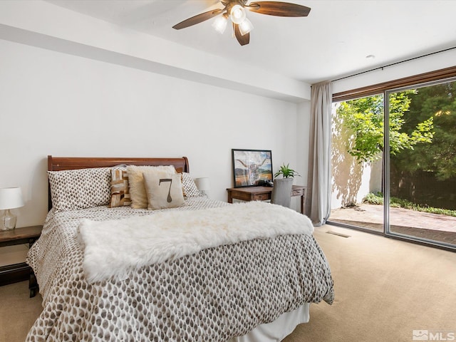 bedroom with access to exterior, light colored carpet, visible vents, and a ceiling fan