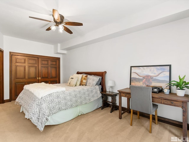 bedroom with a ceiling fan and light colored carpet