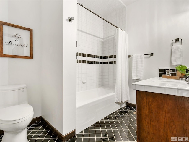 full bath with toilet, vanity, baseboards, tile patterned floors, and shower / bath combo