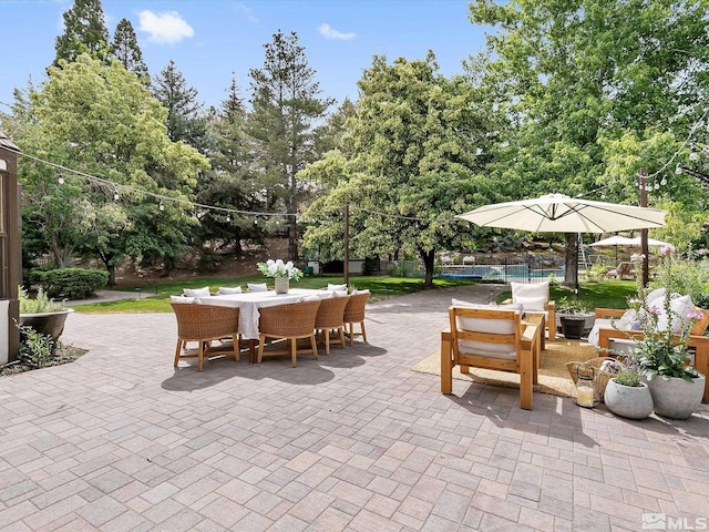 view of patio with outdoor dining space and fence