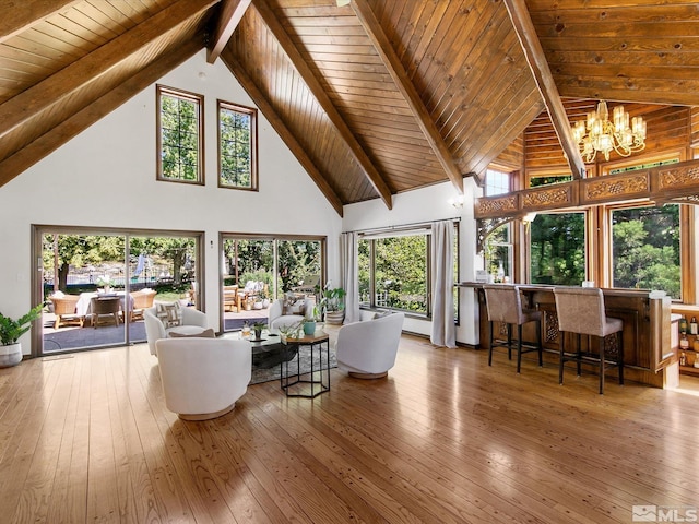 living area featuring a notable chandelier, wood-type flooring, high vaulted ceiling, wooden ceiling, and beamed ceiling