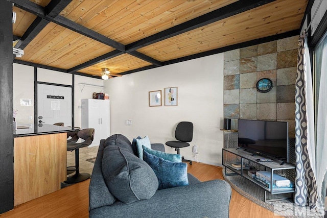 living area featuring wooden ceiling, ceiling fan, wood finished floors, and beamed ceiling