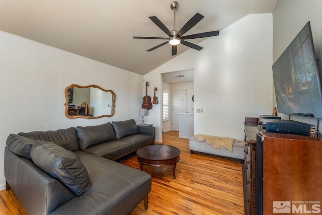 living room featuring light wood finished floors, ceiling fan, and vaulted ceiling