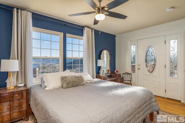 bedroom with ceiling fan and wood finished floors