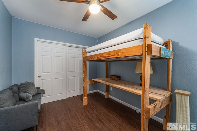 bedroom with a ceiling fan, baseboards, and wood finished floors