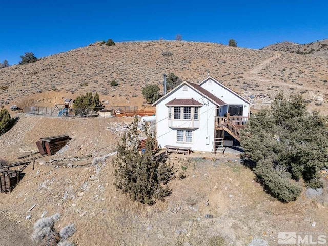 rear view of property featuring stairs