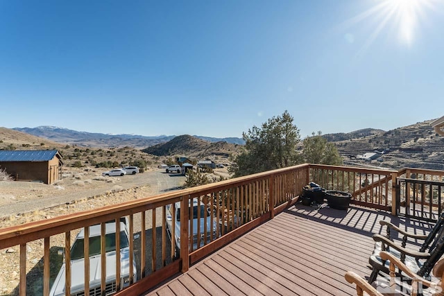 deck with an outdoor structure and a mountain view