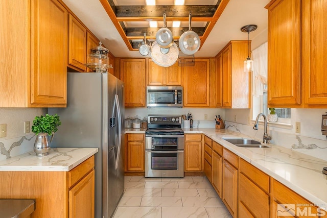 kitchen with stainless steel appliances, marble finish floor, brown cabinetry, and a sink