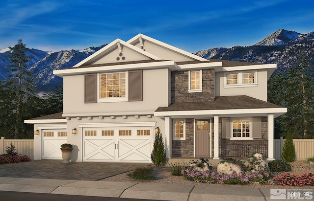 view of front of home featuring stone siding, fence, a mountain view, and stucco siding