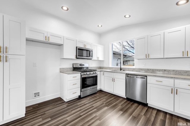 kitchen featuring white cabinetry, appliances with stainless steel finishes, a sink, and recessed lighting