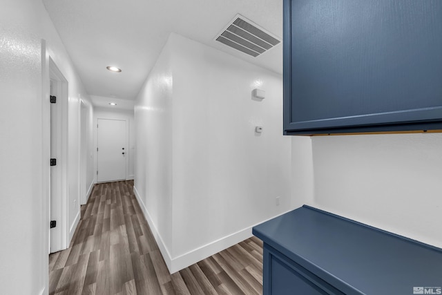 hall featuring recessed lighting, visible vents, baseboards, and wood finished floors