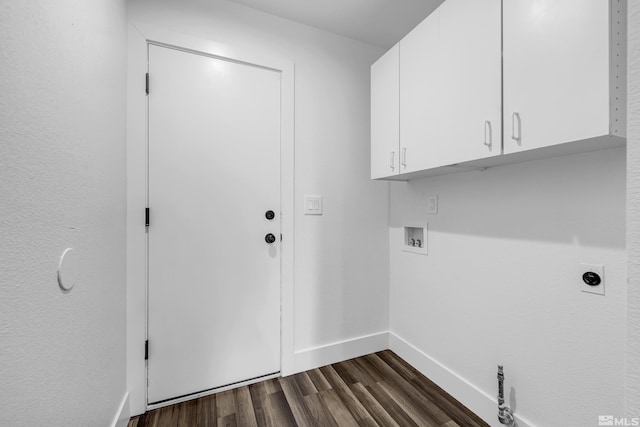 laundry room featuring dark wood-style floors, hookup for a washing machine, cabinet space, electric dryer hookup, and baseboards