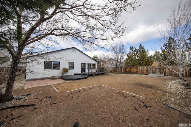 exterior space featuring fence and a wooden deck