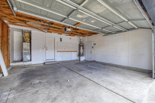 garage with heating unit, gas water heater, and a garage door opener