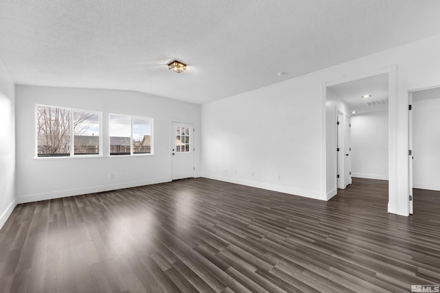 unfurnished living room featuring a textured ceiling, lofted ceiling, visible vents, baseboards, and dark wood-style floors